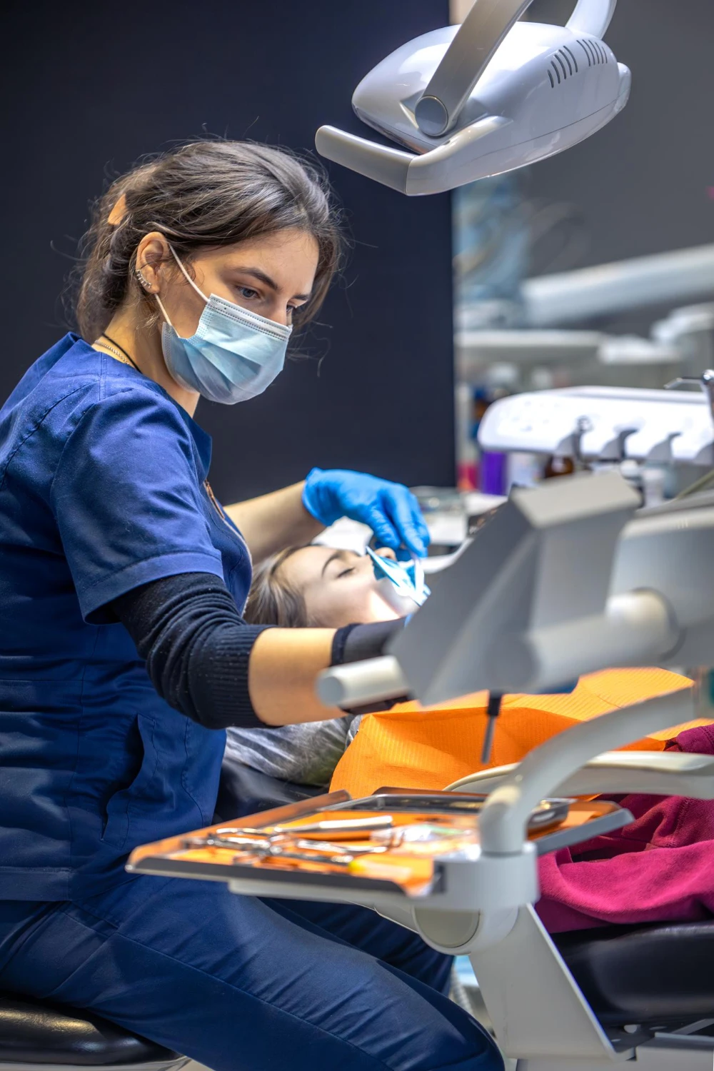 Young female dentist in dental office dentist at work dental treatment concept<br />
